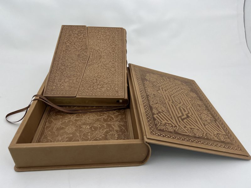 Open leather clamshell traycase with matching embossed volume